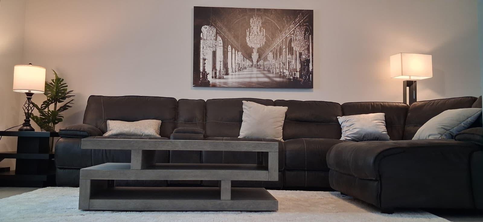 Spacious living room with a large sectional sofa at Angie Home Care AFC